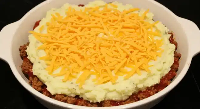 Cowboy Meatloaf and Potato Casserole Quick Guide Assembling cowboy meatloaf and potato casserole with layers of meatloaf and mashed potatoes.