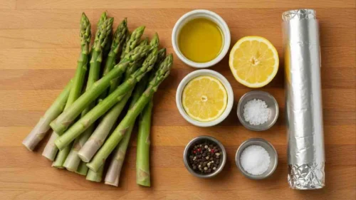 How To Grill Asparagus In Foil – The Best Way To Keep It Tender Ingredients for how to grill asparagus in foil, including fresh asparagus, olive oil, seasonings, and lemon.