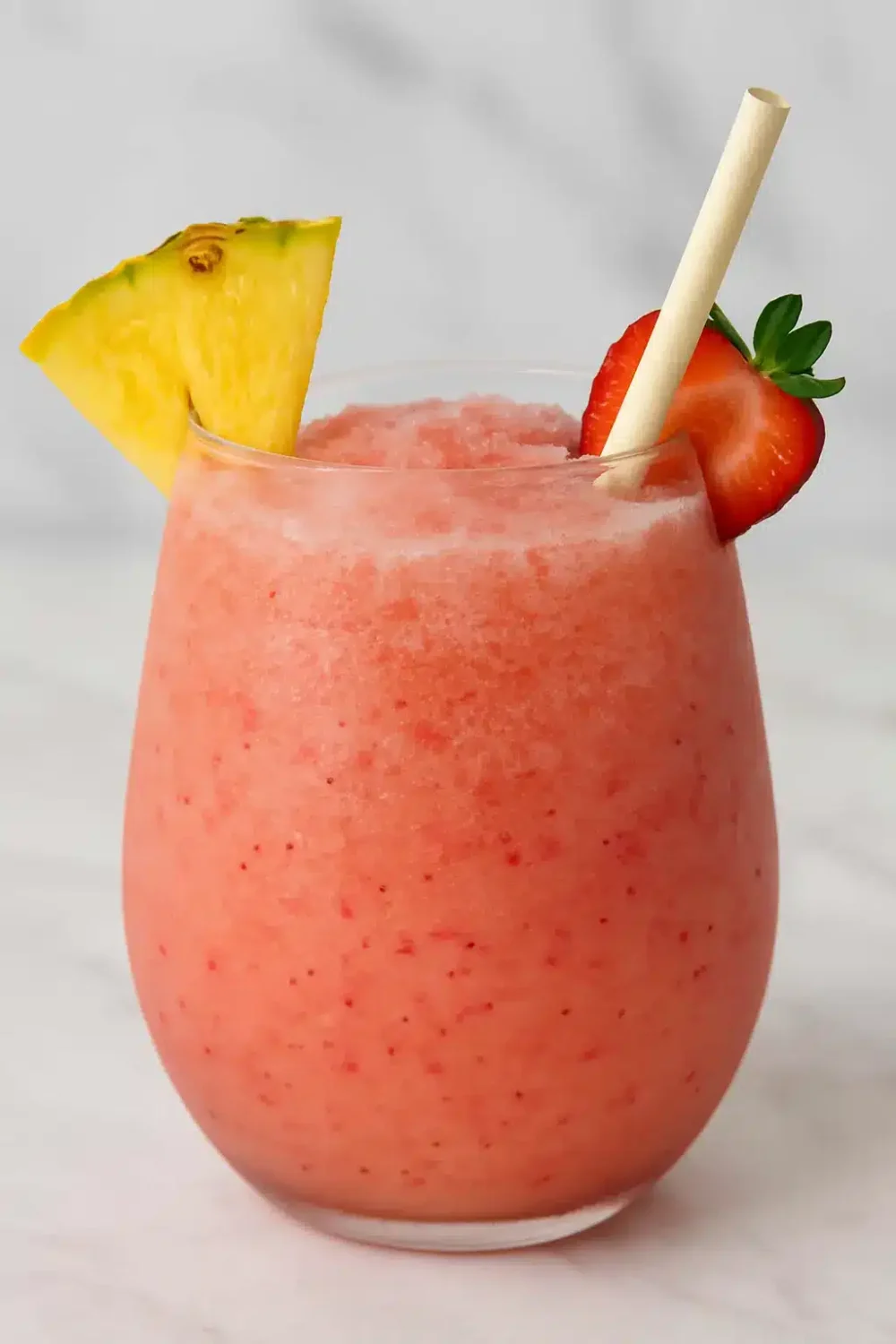 Bahama Mama tropical smoothie recipe in a clear glass with fruit garnish
