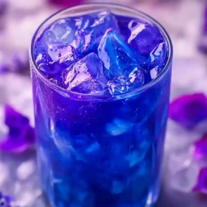 Brazilian Mounjaro Recipe – Vibrant Herbal Detox Tea Brazilian Mounjaro Recipe featuring a glass of vibrant purple and blue butterfly pea flower detox tea