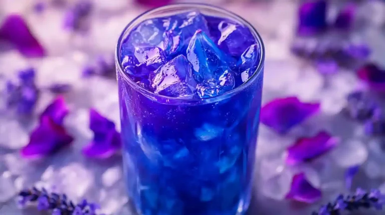 Brazilian Mounjaro Recipe – Vibrant Herbal Detox Tea Brazilian Mounjaro Recipe featuring a glass of vibrant purple and blue butterfly pea flower detox tea