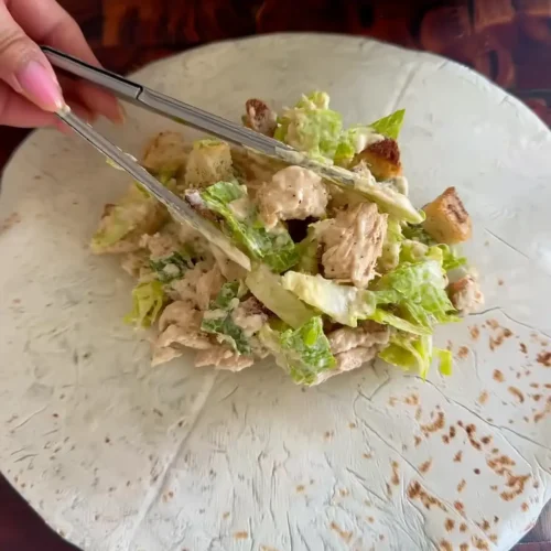 Chicken Caesar Wrap – A Quick and Flavorful Lunch You’ll Love Chicken Caesar Wrap being rolled with salad filling