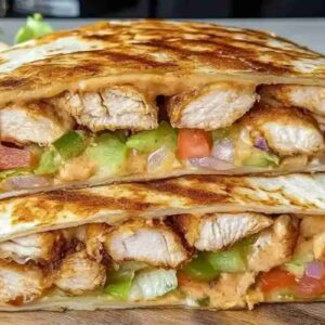 Crispy Chicken Crunch Wrap – Melty, Crunchy, Made at Home Crispy chicken crunch wrap with melted cheese and grilled chicken, placed on Calacatta marble background