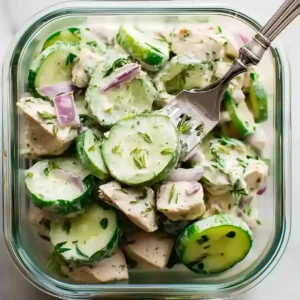 High Protein Cucumber Salad: A Fresh and Filling Bowl high protein cucumber salad with Greek yogurt, red onion and chicken chunks, served in a glass container