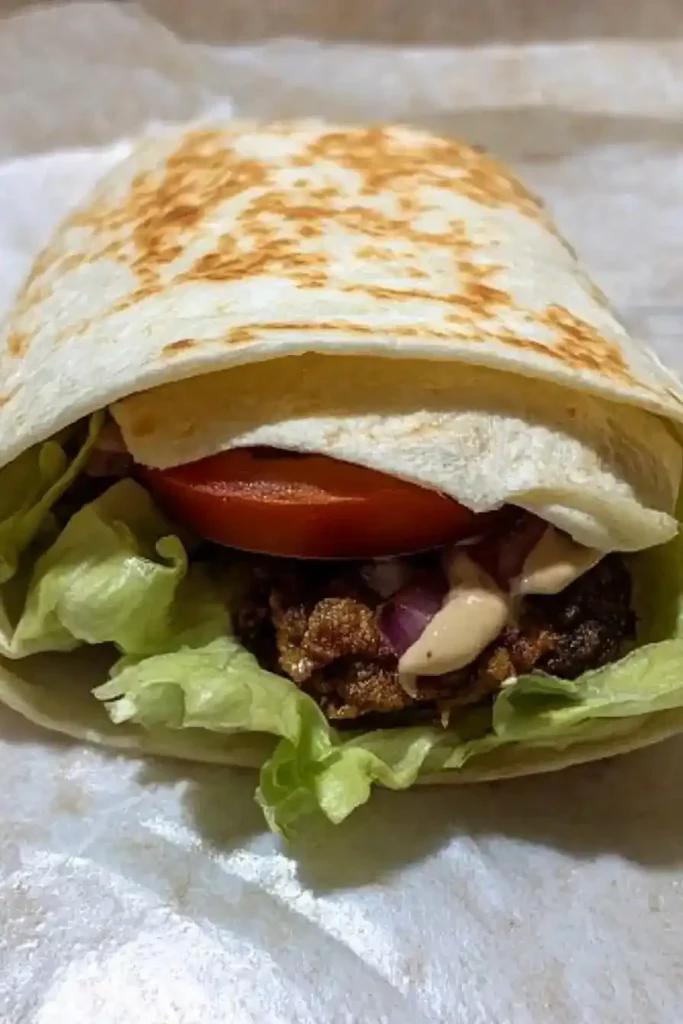 Royal Crunchy Wrap: Your Quick & Crispy Homemade Favorite Royal crunchy wrap before the first bite, placed with visible layers of crispy chicken, tomato, lettuce, and sauce