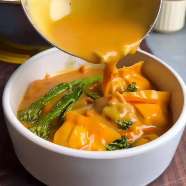5 Minute Katsu Coconut Mango Gyoza Bowl with coconut broth being ladled in