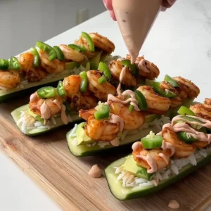 The Ultimate Healthy Snack: Zesty Shrimp Cucumber Boats Shrimp cucumber boats topped with jalapeños and a creamy yogurt sriracha drizzle