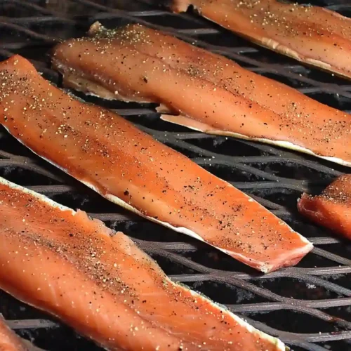 Smoked Trout Recipes: 5 Irresistible Ways to Enjoy This Delicate Fish Cold smoked trout fillets on smoker grate with cracked pepper