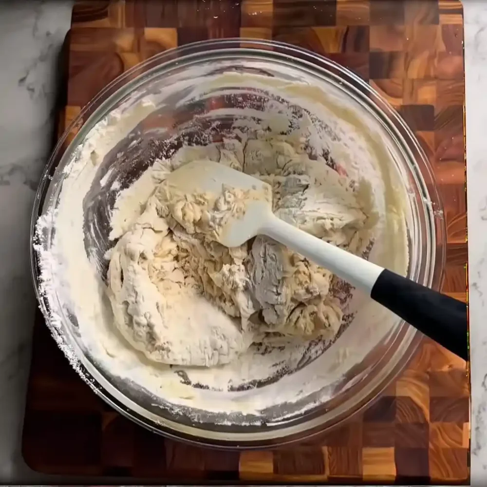 giant garlic knots dough being mixed in a bowl before rising