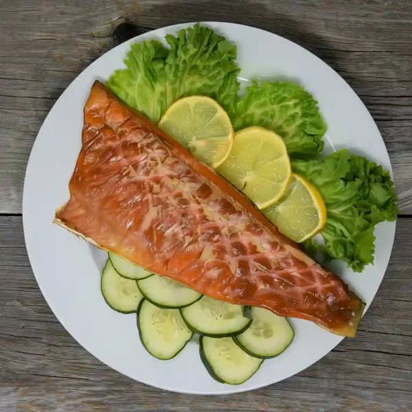 Hot smoked trout fillet served with lemon cucumber and lettuce