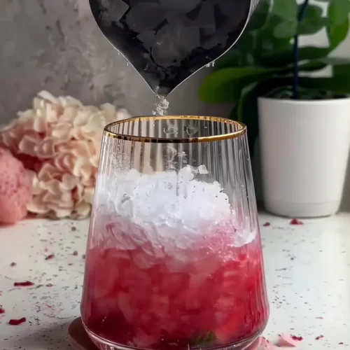 Refreshing Low 30 Calories - Raspberry Lime Mojito Mocktail (No Alcohol) Raspberry Lime Mojito Mocktail in clear glass with crushed ice being poured in