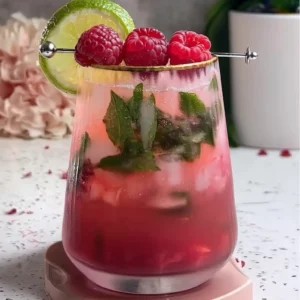 Refreshing Low 30 Calories - Raspberry Lime Mojito Mocktail (No Alcohol) Finished Raspberry Lime Mojito Mocktail garnished with lime and raspberries
