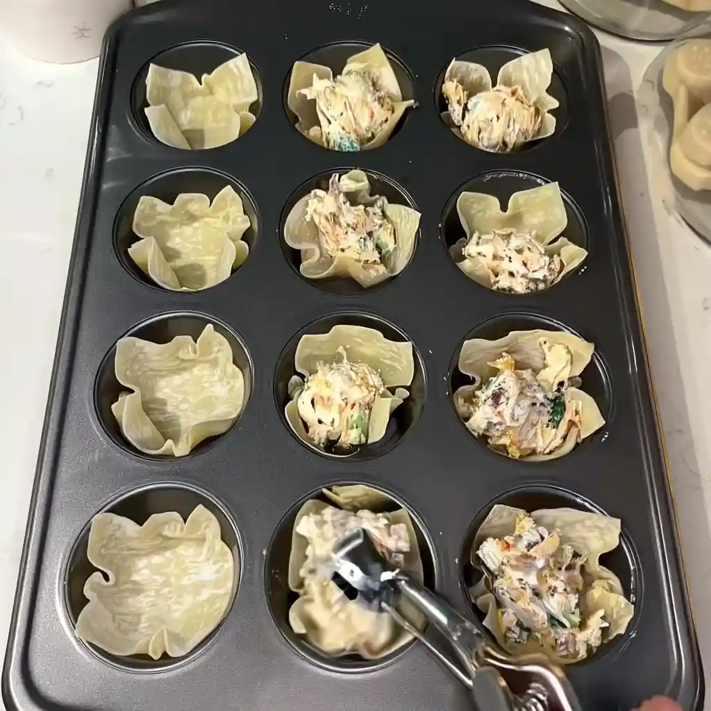 Southwest Cream Cheese Wontons: Easy, Crispy, Cheesy Appetizer Bites Southwest cream cheese wonton filling in muffin cups ready to bake