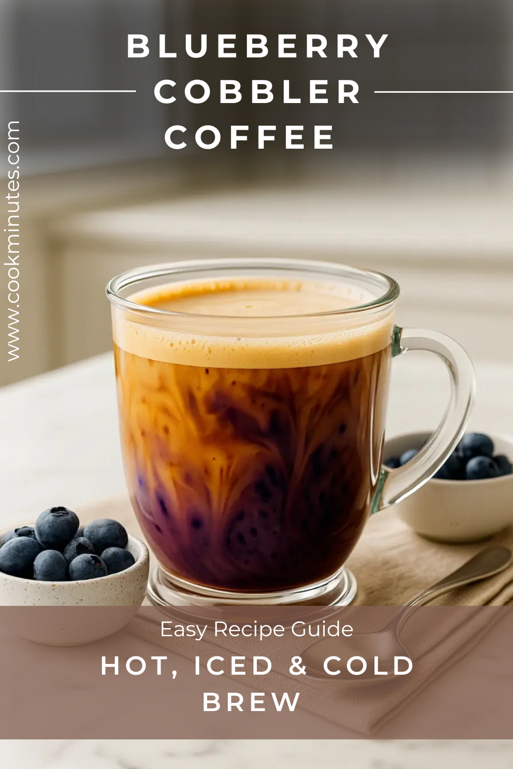 Blueberry Cobbler Coffee Recipe: Hot, Iced & Cold Brew Hot blueberry cobbler coffee in a clear glass mug with marbled syrup and espresso, styled on a white marble counter with fresh blueberries.