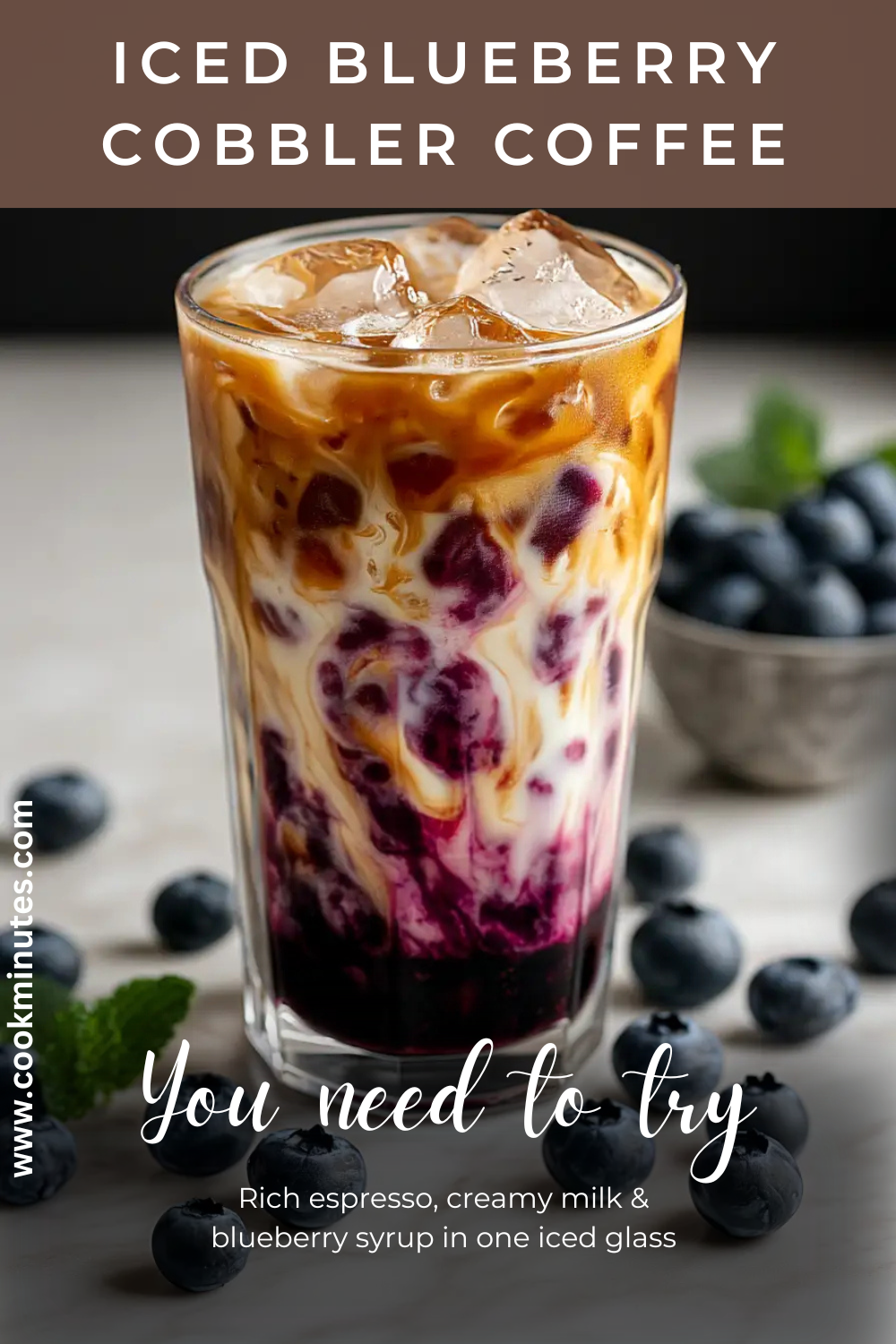 Blueberry Cobbler Coffee Recipe: Hot, Iced & Cold Brew Iced blueberry cobbler coffee in a tall glass with a marbled blend of syrup, milk, and espresso, styled with fresh blueberries.