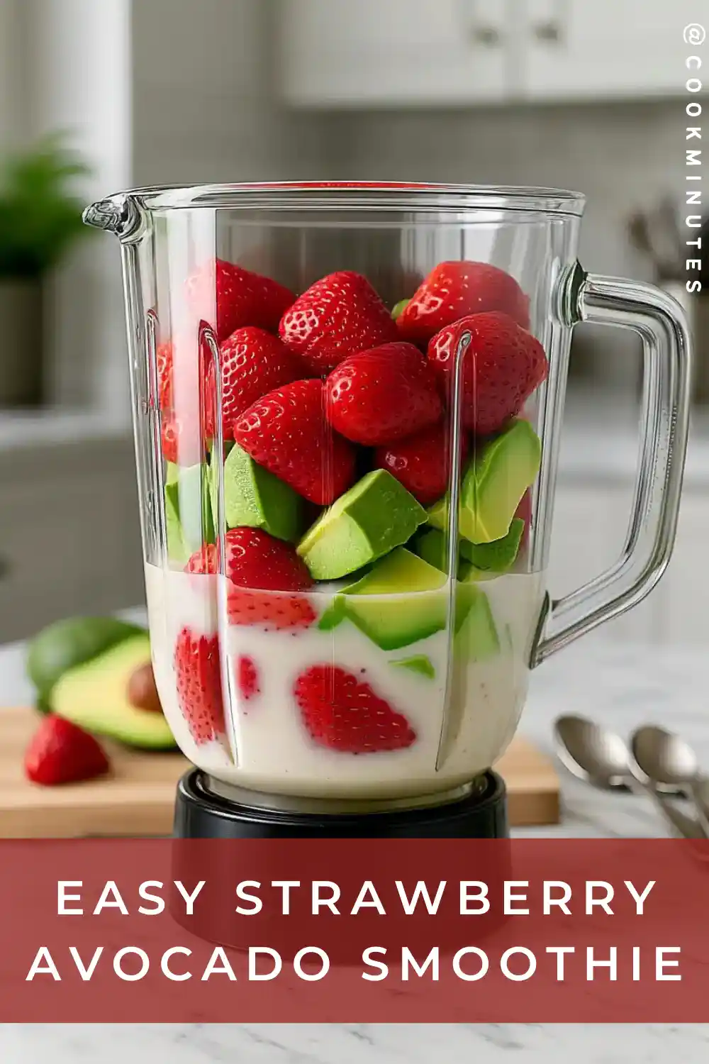 Strawberry Avocado Smoothie: Creamy & Nutritious in 5 Minutes Blender jar filled with fresh strawberries, avocado chunks, and almond milk before blending.