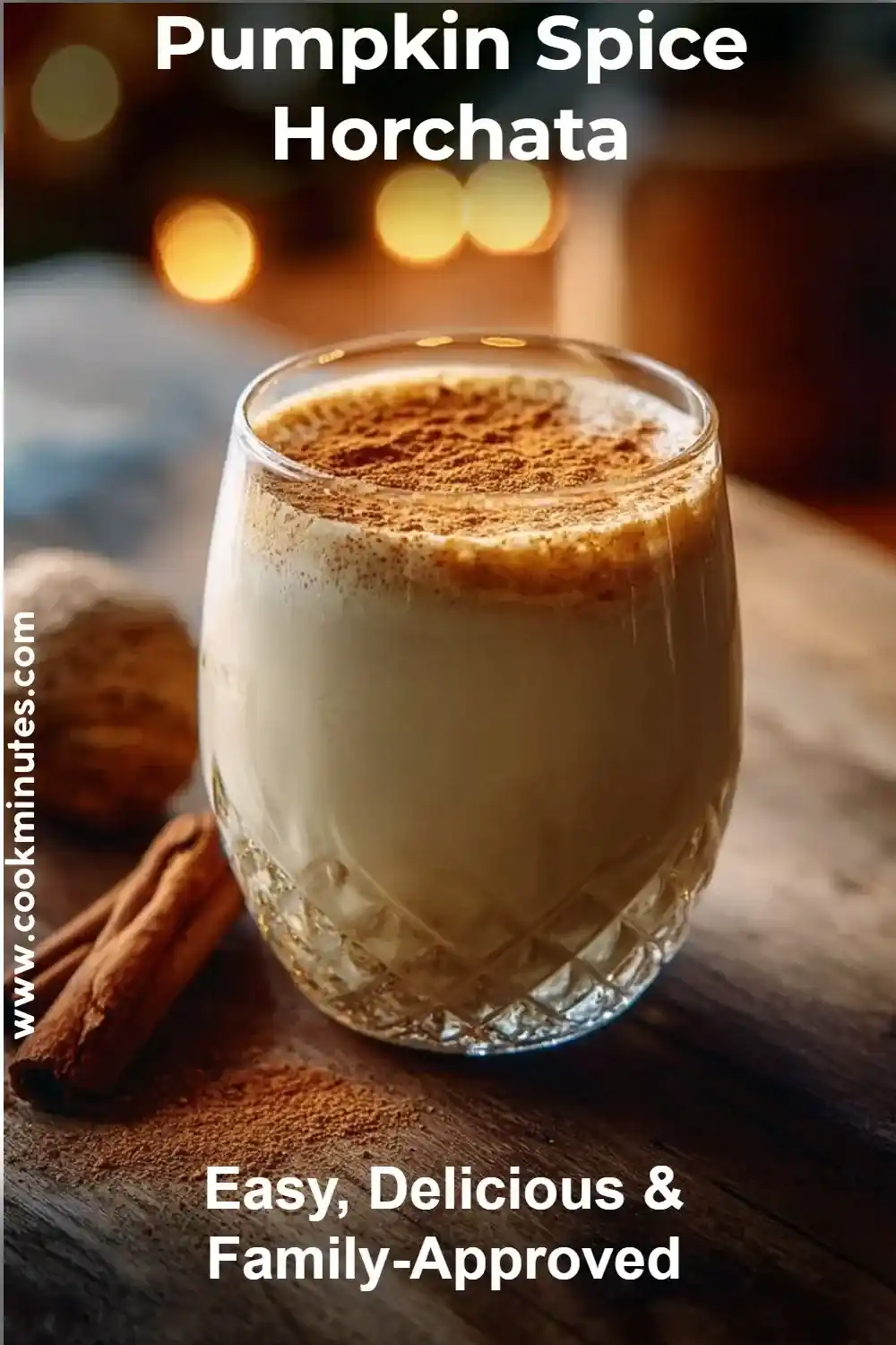 Pumpkin Spice Horchata in a glass topped with cinnamon, surrounded by fall spices.