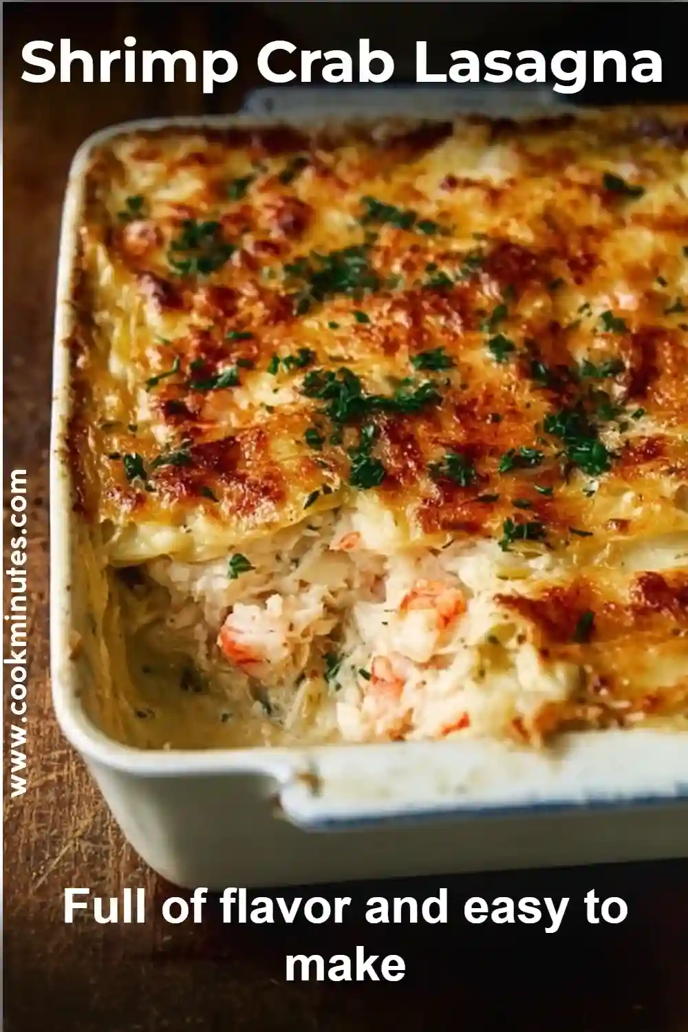 Golden baked shrimp crab lasagna with creamy cheese layers and chopped herbs on top