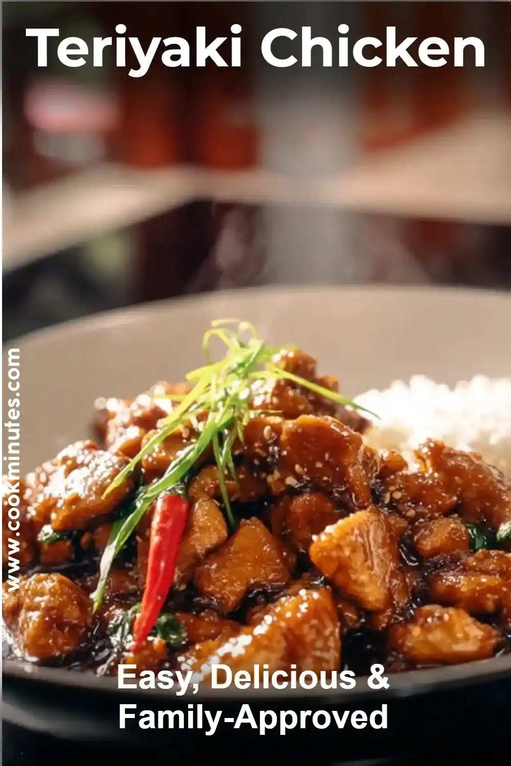 Close-up of slow cooker teriyaki chicken served on rice, topped with sesame seeds and green onions.