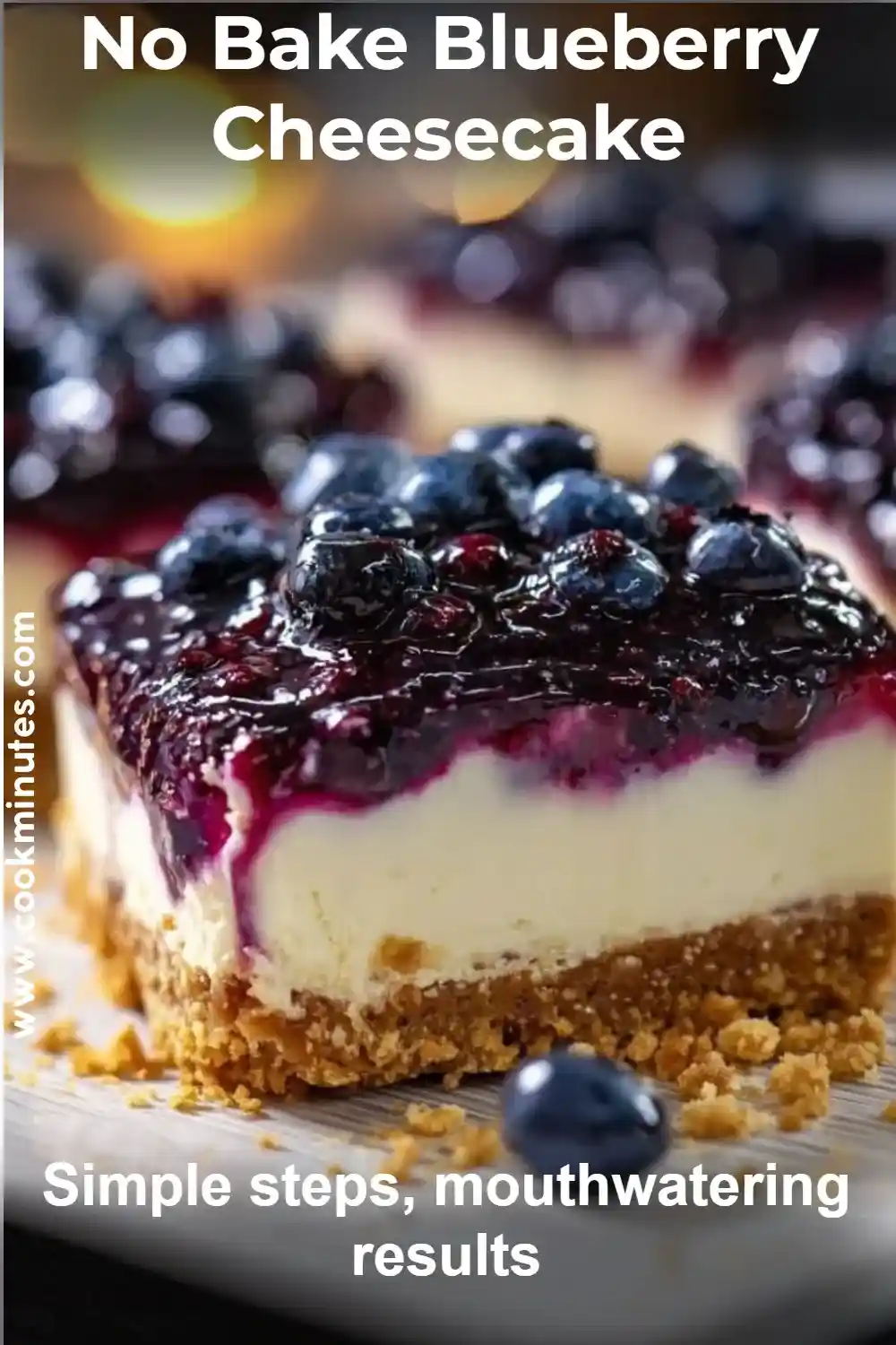 Blueberry cheesecake square with graham crust and fruit topping, surrounded by fresh blueberries
