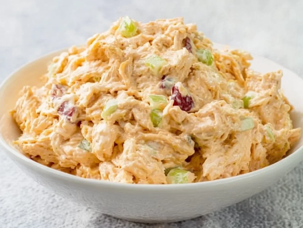 High protein cottage cheese chicken salad in a bowl garnished with herbs.