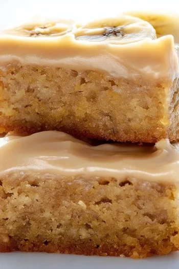 Indulge in the mouthwatering delight of Ooey Gooey Banana Bars, baked to perfection with a rich salted caramel buttercream frosting. Perfect for using up those ripe bananas and satisfying your sweet tooth! banana bars