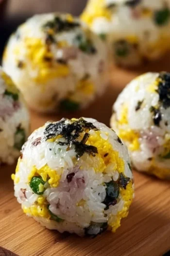 Experience the savory and satisfying joy of Spam Rice Balls – a delightful treat you can easily make at home! Spam Rice Ball