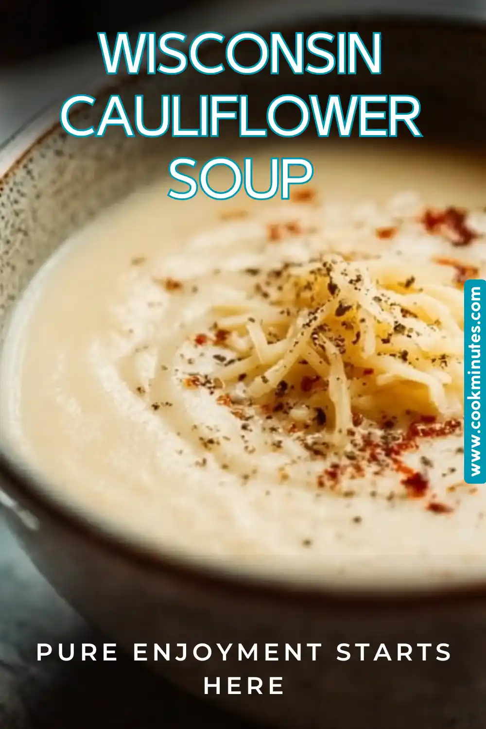 A bowl of Wisconsin Cauliflower Soup, creamy and topped with shredded cheddar cheese.