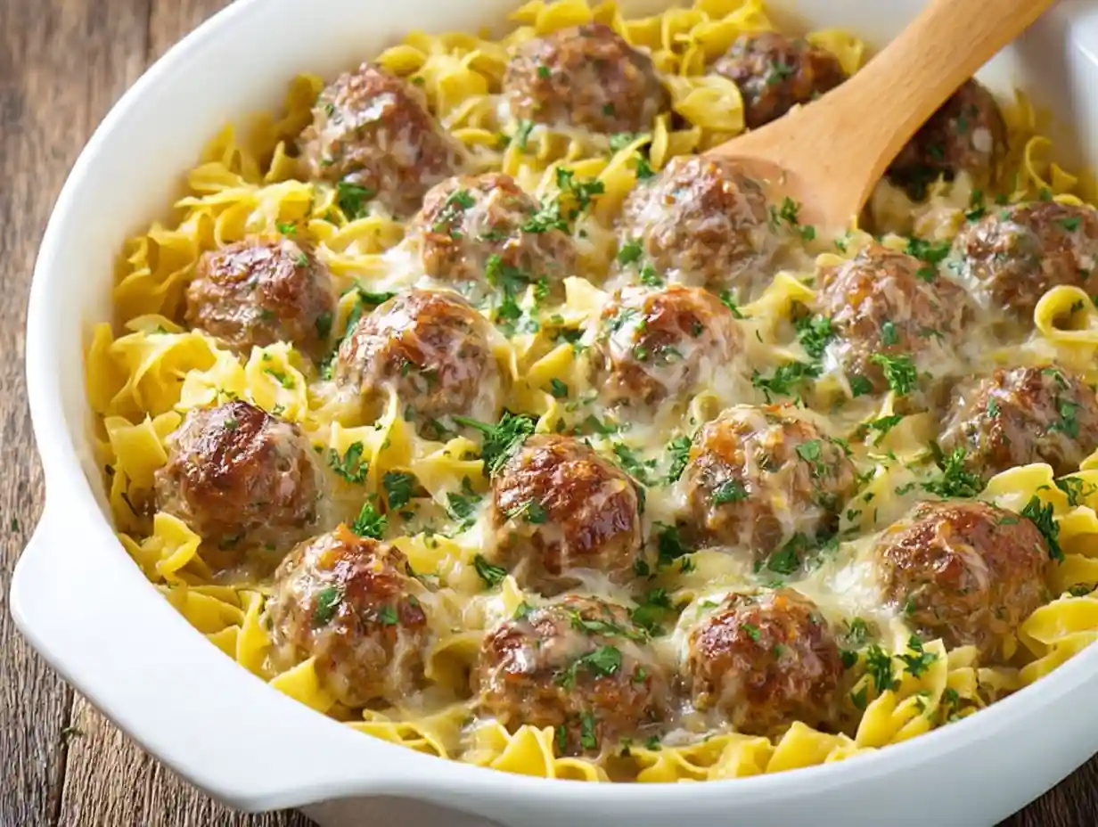 Delicious Swedish Meatball Pasta Bake topped with cheese and herbs