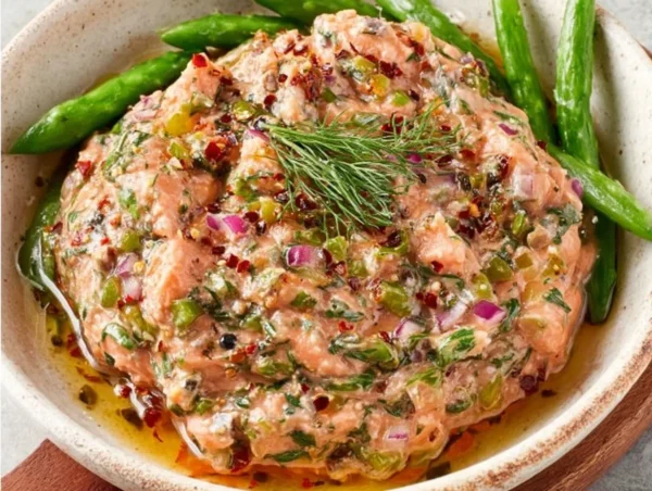 Creamy smoked salmon dip served with crackers and garnished with herbs