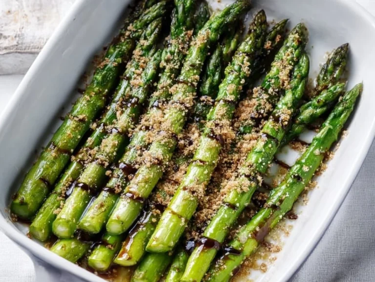 Flavorful Asparagus with Balsamic Glaze: A Quick & Easy Recipe Flavorful asparagus drizzled with balsamic glaze on a white plate.