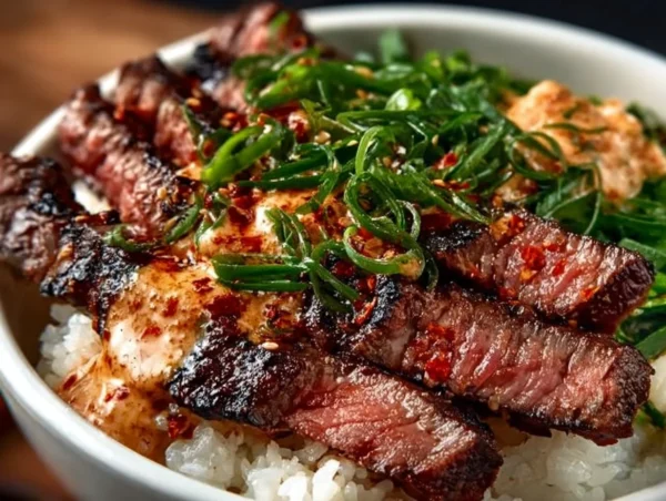 Irresistibly Easy Korean BBQ Steak Rice Bowls with Spicy Cream Sauce Delicious Korean BBQ steak rice bowl with colorful vegetables and rice