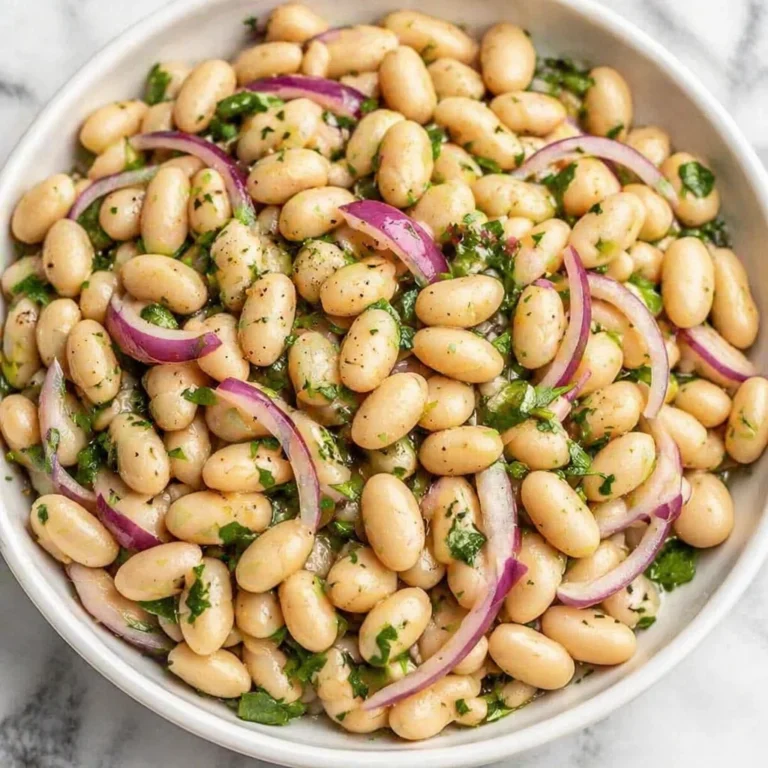 White Bean Salad with Lemon Vinaigrette is my go to fix for those days when I want something fresh, filling, and not even a little complicated. You know the feeling, it is late, you are hungry, and the idea of cooking a whole big meal sounds exhausting. This salad is the kind of thing you can throw together while you are still deciding what to watch or while the kids are asking for a snack. It tastes bright and zippy, but it also has that cozy, satisfying bite from the beans. If you have a can of cannellini beans and a lemon, you are already halfway there. White Bean Salad with Lemon Vinaigrette