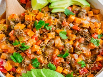 Ground beef and sweet potato skillet meal in a pan, showcasing colorful ingredients