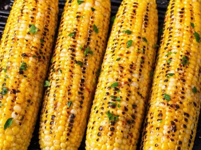 Perfectly grilled corn on the cob with butter and seasonings