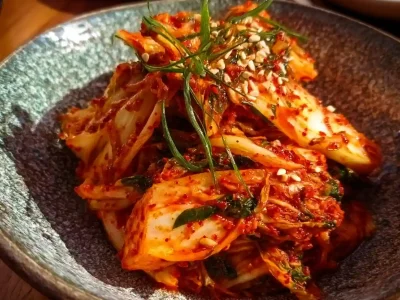 Bowl of vibrant homemade kimchi with fresh vegetables and spices