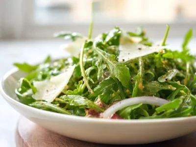 Arugula salad with lemon vinaigrette served in a bowl