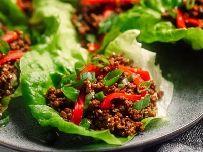 Asian ground beef lettuce wraps served on a plate.