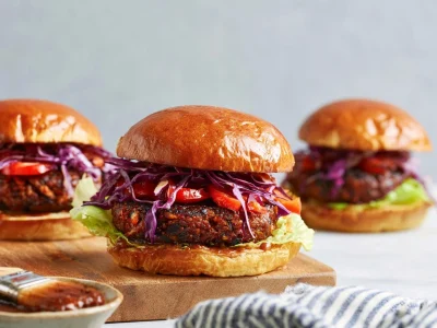 Delicious black bean burger topped with smoky BBQ sauce and garnishes