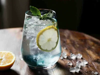 Blue salt trick beverage with lemon slices and mint garnish
