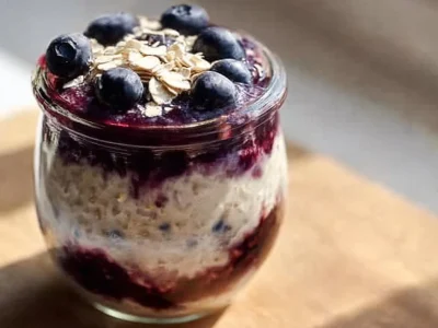 Bowl of blueberry overnight oats topped with fresh blueberries and almonds
