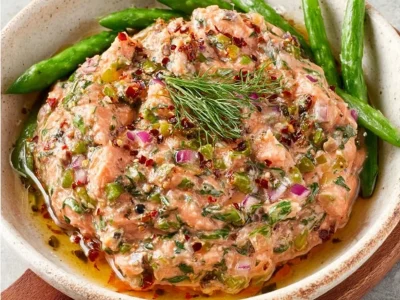 Creamy smoked salmon dip served with crackers and garnished with herbs