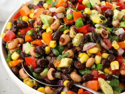 Avocado Cowboy Caviar with Lime Dressing featuring beans, corn, and fresh vegetables.