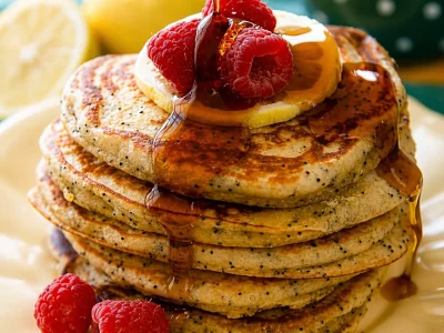 Delicious lemon poppy seed pancakes topped with a lemony glaze.