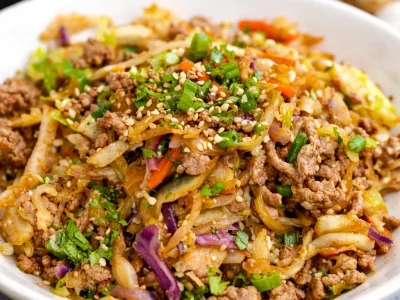 A colorful bowl of Egg Roll in a Bowl featuring ground meat and fresh vegetables.