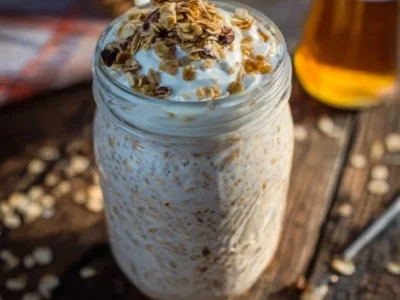Bowl of French Toast Overnight Oats topped with fruits and syrup