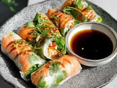 Fresh salmon spring rolls with colorful vegetables and herbs