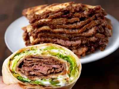 Delicious homemade doner kebab served with fresh vegetables and sauces