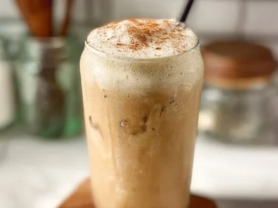 Refreshing Iced French Toast Latte topped with cinnamon and whipped cream