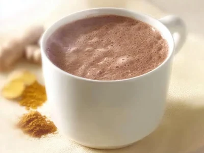 Bowl of immunity boosting hot chocolate topped with whipped cream and spices